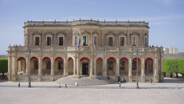 Pan shot of the gorgeous ancient historical building of the City Hall of Noto, Sicily, Italy.