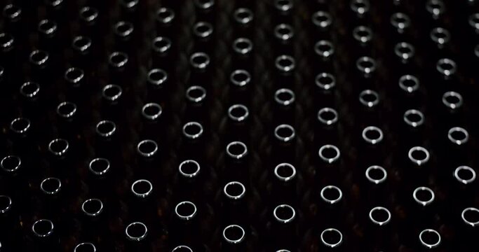 Close-up of brown bottles in a factory. A long row of glass bottles. Top view of a production line. Factory concept. Factory brewery concept.