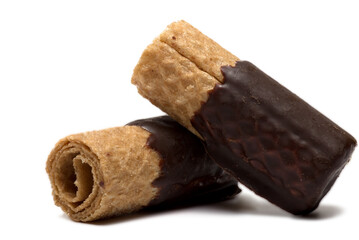 Closeup rolled wafers covered chocolate white background