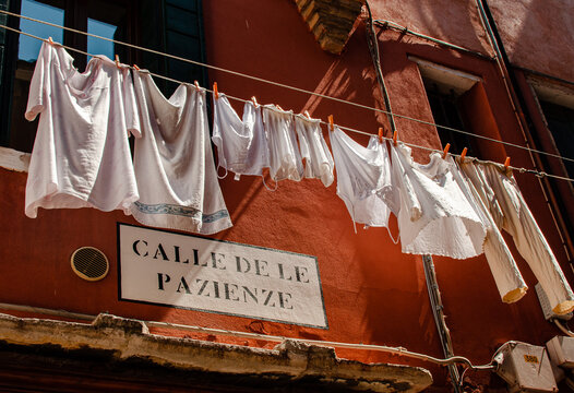 White clothing drying outside a Venetian building in Spring
