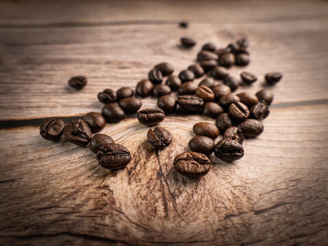 Close Up Shot Of Coffee Beans Was Poured On The Wooden Floor Focus At Some Point Gives A Warm Light To A Warm Mood Insert A Little Darkness Shooting In The Studio