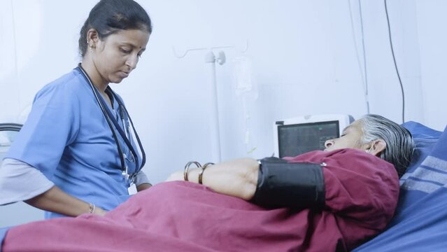 Nurse or doctor checking bp or blood pressure of senior sick patient at hospital on bed - concept of treatment, routine checkup and healthcare