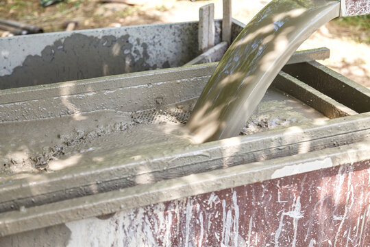 Rotary drilling rig at a construction site.Sludge flow from the joule during the water well drilling