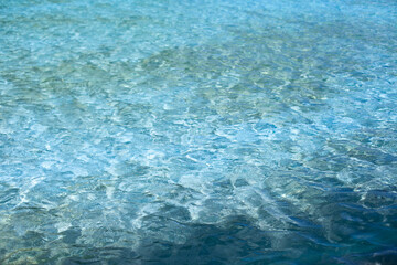 Water in the pool texture and background. Blue and green waters with ripples from breeze on sunny day
