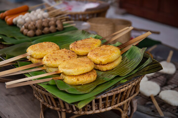 Grilled rice ball/thai food,Khao Jee: grilling yellow sticky rices, Thai style grilling sticky rices on charcoal stove, grilling sticky rices coated with egg paste.