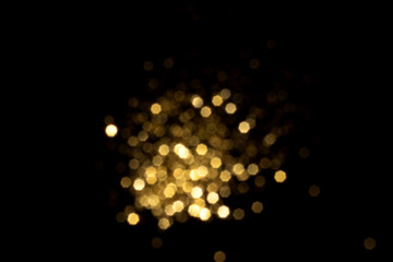 Golden blurred bokeh lights on black background. Glitter sparkle stars for celebrate. Overlay for...