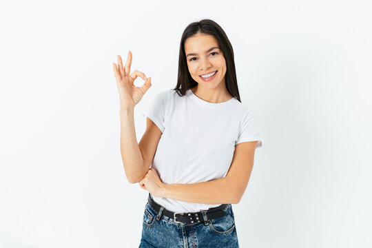Cheerful confident woman wearing white T-shirt and blue jeans