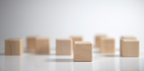 Several wooden blocks were empty and one was clearly placed in front of them. with blurred wooden blocks in the background For text area copy area