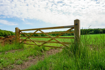 view over wooden gate to countryside field. rural farmland in England UK. 