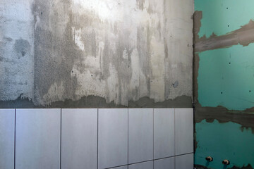 Home renovation, laying ceramic tiles on the wall