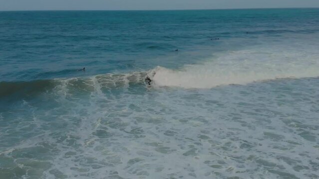 aerial view of surfer riding on Coxos beach in Ericeira, is part of the world surf reserve in Ericeira, Portugal.