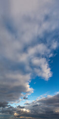 Obraz premium Fantastic thunderclouds at sunrise, vertical panorama