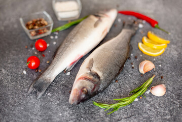 raw sea bass fish on stone background