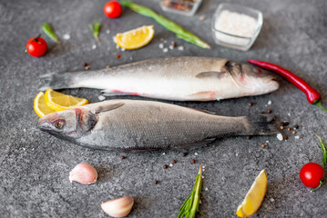raw sea bass fish on stone background