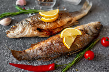 Baked sea bass fish on a stone background