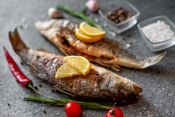 Baked sea bass fish on a stone background
