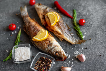 Baked sea bass fish on a stone background