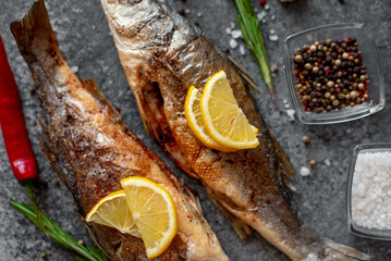 Baked sea bass fish on a stone background