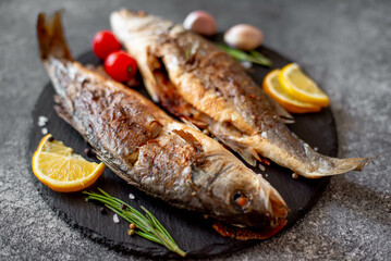 Baked sea bass fish on a stone background