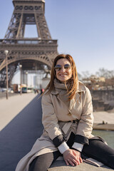 Obraz premium Happy travel woman near the Eiffel tower, Paris. Travel tourist girl on vacation resting happy outdoors. 