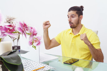 surprised man in front of his laptop