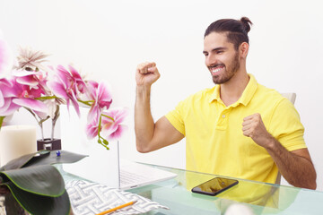 man celebrating in front of his laptop
