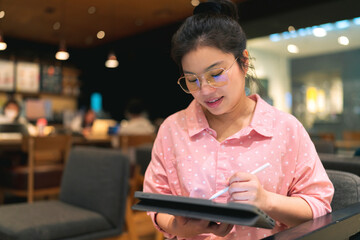 relax leisure attractive smart asian female freelance entrepreneur smile and enjoy working with smartphone and laptop tablet at cafe restaurant digital nomad expat casual ideas work anywhere concept - obrazy, fototapety, plakaty