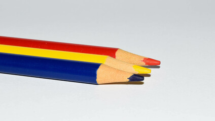 Colored pencils background. Color pencils on white background. Romanian flag