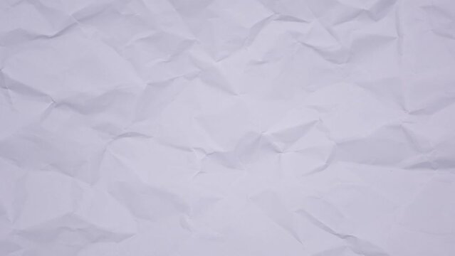 Crumpled wrinkled sheet of paper background texture. Stop motion animation. Seamless looping.