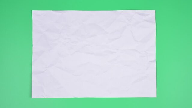 Crumpled wrinkled sheet of paper background texture. Stop motion animation. Seamless looping.