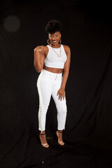 Fototapeta na wymiar Lovely black woman in a white outfit and a smile
