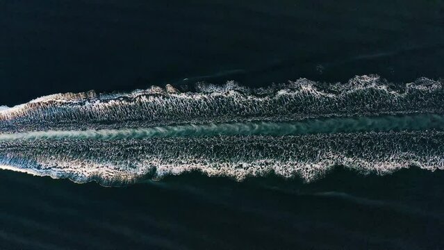 Ships wake, top view. Aerial drone shot over the boat. Foam trail with waves. High speed white yacht from above. Ocean Waves, Aerial Drone Shot Over Speed Boat