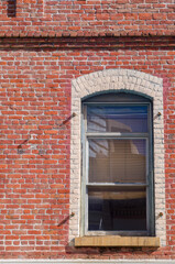 Old Red Brick Building with a Victorian Style Arched Window.