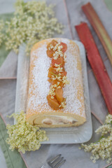 Sweet home made biscuit roll with rhubarb and elderflower on a table