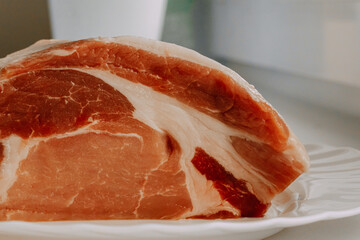 Raw meat on a white plate