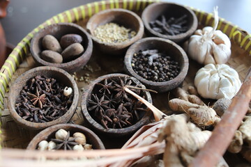 Blurry A view of the mixture of spices, herbs and cooking ingredients in the rattan pan.