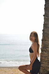 beautiful tanned girl in trendy bikini on beach tropical island. Summer vacation, travel around the world, advertising swimwear new season