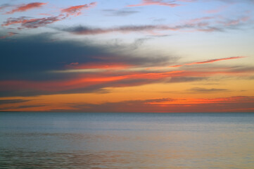 Colorful sky with red, blue and orange colors with calm empty sea