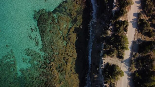 Aerial drone view of the rocky coast and the Mediterranean Sea near the scenic Aphrodite Trail in the Akamas Peninsula National Park, Cyprus. Famous tourist travel destination near Polis city, Cyprus