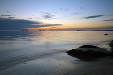 Colorful sky after sunset with reflection on water on a beach