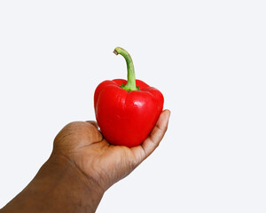 hand holding red pepper