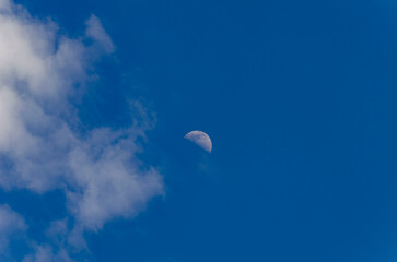 Increscent moon on blue sky background.