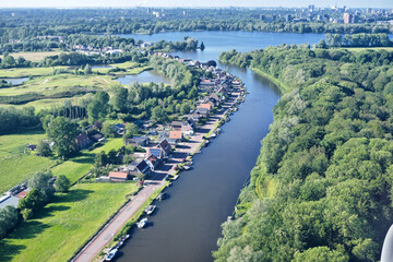Fototapeta premium Aerial view of Nieuwemeerdijk canal and Nieuwe Meer in Amsterdam, The Netherlands.