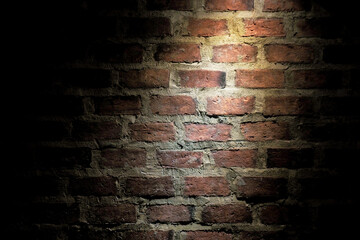 Abstract patterned image of an old brick wall illuminated by spotlights. for use as a background