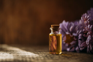 oil and flowers. Oil bottle. Spa concept. Spa. Glass. Wellness. Cosmetic. Photo. Background. Flowers. 