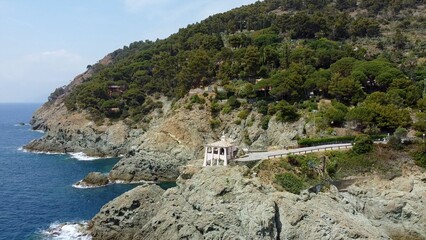 Europe, Italy , Liguria, Bonassola - Drone aerial view of Madonnina della Punta a little pink Catholic church monastery on the rock overlooking the Mediterranean sea