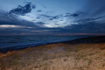 Baltic sea shore (sand dunes, beach) at night. Sunset, midnight sun. Picturesque panoramic scenery....