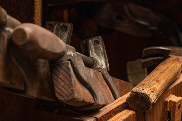 Collection of various antique wood working tools and hand tools in vintage wooden carpenter's tool box