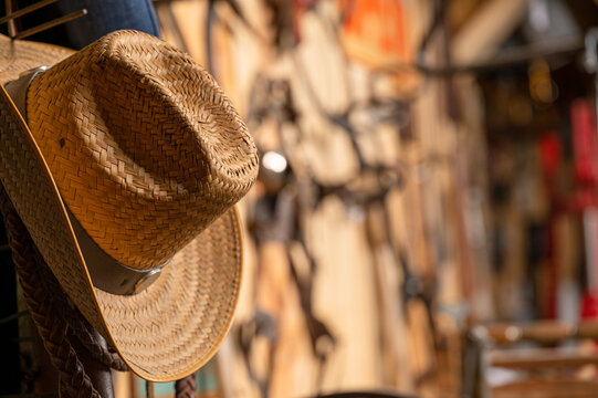 Cowboy hat hanging by wall of antique tools in a vintage barn shed