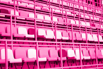 Obraz premium Pink plastic seats or chairs at stadium background